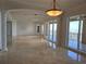 Spacious living room with marble floors, decorative columns, and sliding glass doors with balcony access at 35 Watergate Dr # 1103, Sarasota, FL 34236