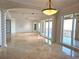 Expansive living room with marble floors, recessed lights, and floor to ceiling sliding glass doors at 35 Watergate Dr # 1103, Sarasota, FL 34236