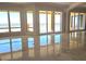 Bright living room boasts water views from large windows and sliding doors to multiple balconies at 35 Watergate Dr # 1103, Sarasota, FL 34236