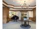 Welcoming lobby featuring wood trim, a grand piano, and stylish furnishings for residents and guests at 35 Watergate Dr # 1103, Sarasota, FL 34236