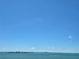 Expansive ocean view with clear blue sky, showcasing tranquil waters and distant cityscape from this home at 35 Watergate Dr # 1103, Sarasota, FL 34236