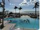 Resort-style swimming pool with palm trees and ocean views, creating a relaxing tropical oasis at 35 Watergate Dr # 1103, Sarasota, FL 34236