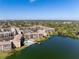 Aerial view of the community showcasing the buildings, lake, pool, and dock at 3664 Lake Bayshore Dr # K323, Bradenton, FL 34205