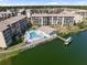 Aerial view showcasing the condos, lakeside pool, and community amenities by the water at 3664 Lake Bayshore Dr # K323, Bradenton, FL 34205