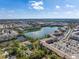 Scenic aerial showing the condo community situated by a lake with lush greenery at 3664 Lake Bayshore Dr # K323, Bradenton, FL 34205