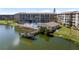 Aerial view of lakeside condos featuring a pool and dock, perfect for lakeside enjoyment at 3664 Lake Bayshore Dr # K323, Bradenton, FL 34205