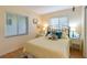 Bright bedroom featuring a queen size bed, stylish lamps, and decorative artwork at 3664 Lake Bayshore Dr # K323, Bradenton, FL 34205