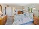 Inviting bedroom with a queen bed, soft lighting, and a view towards the walk-in closet and bathroom at 3664 Lake Bayshore Dr # K323, Bradenton, FL 34205