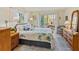 Well-lit bedroom featuring a queen-sized bed and a sliding glass door to the enclosed lanai at 3664 Lake Bayshore Dr # K323, Bradenton, FL 34205