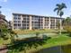 Well-maintained condo exterior featuring a bocce court, a pond and manicured landscaping at 3664 Lake Bayshore Dr # K323, Bradenton, FL 34205