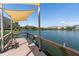 Community dock with a sunshade and bench, providing views of the lake at 3664 Lake Bayshore Dr # K323, Bradenton, FL 34205