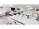 Bright community room with tables, chairs, TV, and game area for resident activities at 3664 Lake Bayshore Dr # K323, Bradenton, FL 34205