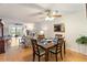 Dining area with hardwood floors and view to living room and outside the sliding glass doors at 3664 Lake Bayshore Dr # K323, Bradenton, FL 34205