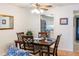 A dining area features a wooden table set for four, illuminated by a ceiling fan, and adjacent to a well-lit kitchen at 3664 Lake Bayshore Dr # K323, Bradenton, FL 34205