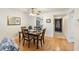 Dining area featuring a wooden table set for four, seamlessly connecting to the kitchen and hallway at 3664 Lake Bayshore Dr # K323, Bradenton, FL 34205