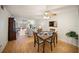 Bright dining area featuring a four-chair wood table and a ceiling fan, seamlessly blending into the living space at 3664 Lake Bayshore Dr # K323, Bradenton, FL 34205