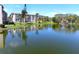 Scenic waterfront condo complex with lush landscaping and serene lake views on a clear, sunny day at 3664 Lake Bayshore Dr # K323, Bradenton, FL 34205