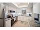 Contemporary kitchen featuring stainless steel appliances, white cabinetry, and granite countertops at 3664 Lake Bayshore Dr # K323, Bradenton, FL 34205