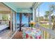 Enclosed Lanai with sliding doors, table, and chair with a view back into the bedroom at 3664 Lake Bayshore Dr # K323, Bradenton, FL 34205