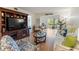 Open living room with comfortable seating, entertainment center, and a view of the seating area by the window at 3664 Lake Bayshore Dr # K323, Bradenton, FL 34205