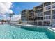 Community pool with palm trees and lounge chairs, perfect for relaxation and recreation at 3664 Lake Bayshore Dr # K323, Bradenton, FL 34205