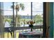Relaxing lanai view of a lakefront complex with palm trees and grass at 3664 Lake Bayshore Dr # K323, Bradenton, FL 34205