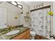 Well-lit bathroom with elegant vanity, modern fixtures, and decorative shower curtain at 3809 21St W Ave, Bradenton, FL 34205
