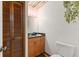 Cozy powder room with wood accents, granite countertop, and decorative greenery at 3809 21St W Ave, Bradenton, FL 34205