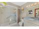 Bathroom featuring a walk-in shower, blue vanity, and neutral decor at 3809 21St W Ave, Bradenton, FL 34205