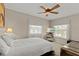 Bright bedroom with neutral walls, a ceiling fan, and a mirrored nightstand with a television at 3809 21St W Ave, Bradenton, FL 34205