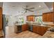Well-lit kitchen with wood cabinets, granite countertops, and a wine cooler, perfect for cooking and entertaining at 3809 21St W Ave, Bradenton, FL 34205