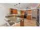 Well-equipped kitchen featuring granite countertops, wooden cabinets, and stainless steel appliances at 3809 21St W Ave, Bradenton, FL 34205