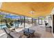 Enclosed patio featuring a seating area, ceiling fan and access to the pool area at 3809 21St W Ave, Bradenton, FL 34205