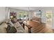 Bright living room with pool views, stylish furnishings, and wood-look flooring at 3809 21St W Ave, Bradenton, FL 34205