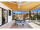 Cozy screened-in patio with comfortable seating and a ceiling fan, ideal for relaxation and outdoor entertaining at 3809 21St W Ave, Bradenton, FL 34205