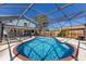 Inviting screened-in pool with clear blue water, a red brick trim, and a spacious patio area at 3809 21St W Ave, Bradenton, FL 34205