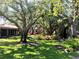 Lush backyard with mature trees, offering shade and natural beauty in a peaceful setting at 3818 Sun Eagle Ln, Bradenton, FL 34210