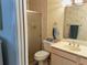 Tiled bathroom featuring a toilet, sink, shower with glass door, and towel rack at 3818 Sun Eagle Ln, Bradenton, FL 34210