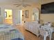 Bedroom with light yellow walls, a ceiling fan and views into the bathroom and kitchen at 3818 Sun Eagle Ln, Bradenton, FL 34210