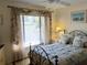 Inviting bedroom featuring a window with blinds and a black metal bed frame at 3818 Sun Eagle Ln, Bradenton, FL 34210