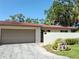 Charming home featuring a terra cotta tile roof, neutral stucco, and an attached two-car garage at 3818 Sun Eagle Ln, Bradenton, FL 34210