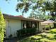 Rear exterior view featuring mature trees, large window and private fenced yard at 3818 Sun Eagle Ln, Bradenton, FL 34210