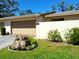 Landscaped front yard with beautiful flowers and lush green grass at 3818 Sun Eagle Ln, Bradenton, FL 34210