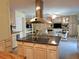 Kitchen island features granite countertops, lots of cabinets, and stainless steel vent hood at 3818 Sun Eagle Ln, Bradenton, FL 34210