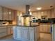 Spacious kitchen featuring light wood cabinets and a central island at 3818 Sun Eagle Ln, Bradenton, FL 34210