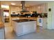 Open kitchen with island, custom cabinetry and dining area at 3818 Sun Eagle Ln, Bradenton, FL 34210