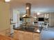 Kitchen island features granite countertops, lots of cabinets, and stainless steel vent hood at 3818 Sun Eagle Ln, Bradenton, FL 34210