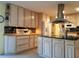 Kitchen featuring an island with black granite countertops, light colored cabinetry, and a refrigerator at 3818 Sun Eagle Ln, Bradenton, FL 34210
