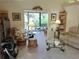Cozy living room with rattan furniture and access to a screened lanai at 3818 Sun Eagle Ln, Bradenton, FL 34210