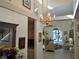 Open-concept living room with chandelier, vaulted ceilings and neutral colors at 3818 Sun Eagle Ln, Bradenton, FL 34210